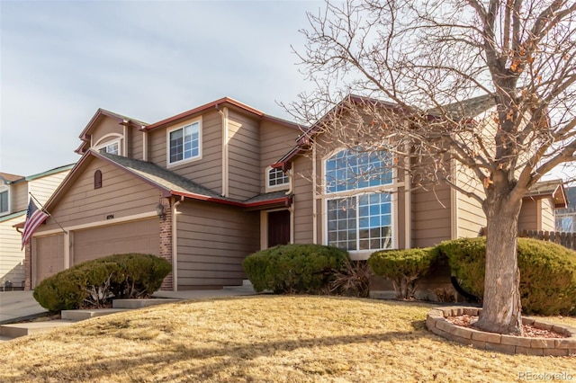 view of front of property featuring brick siding and a garage