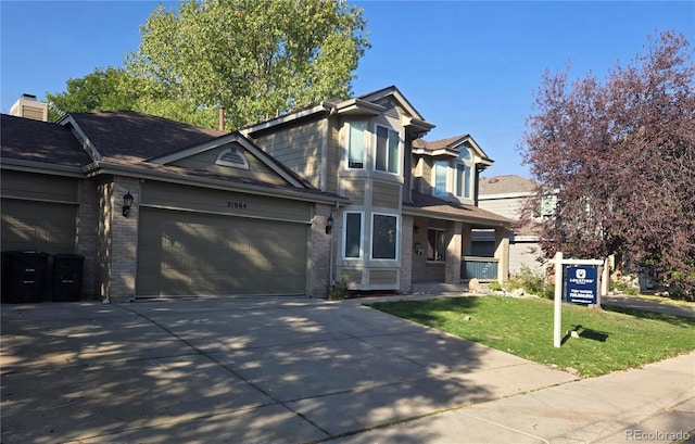 21064 E Crestline Cir, Centennial, CO 80015 - traditional home with brick siding, a garage, concrete driveway, and a front yard