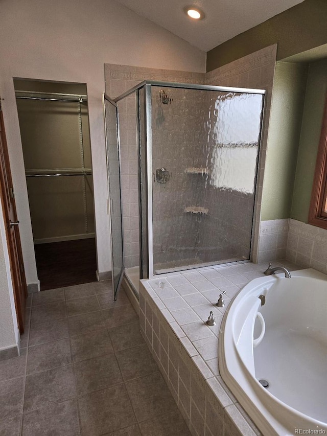 21064 E Crestline Cir, Centennial, CO 80015 - full bath featuring a shower stall, a garden tub, tile patterned floors, and vaulted ceiling