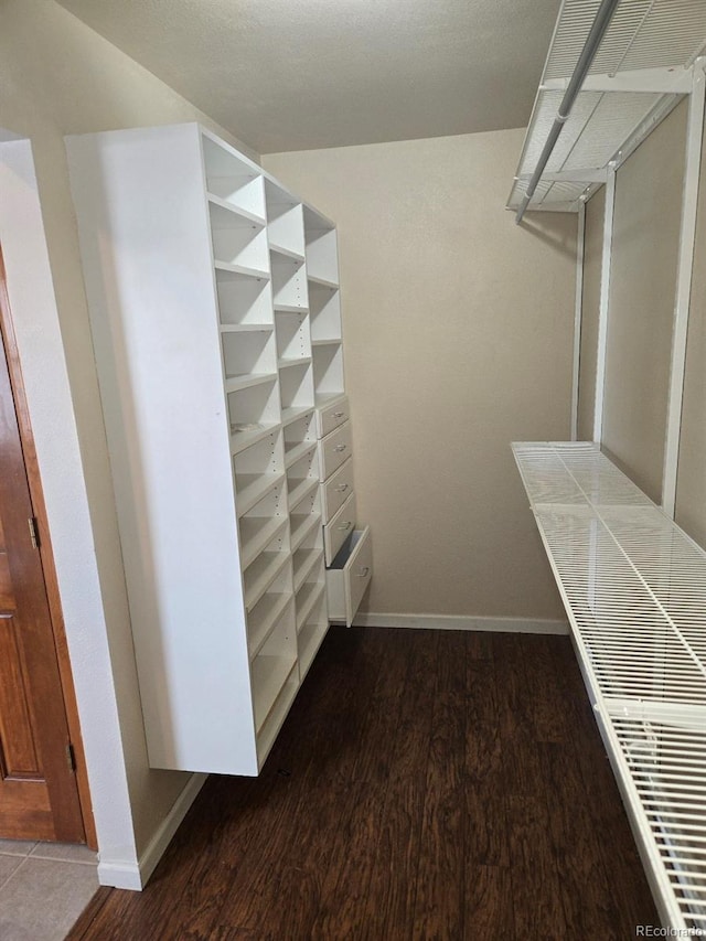 walk in closet featuring dark hardwood / wood-style flooring