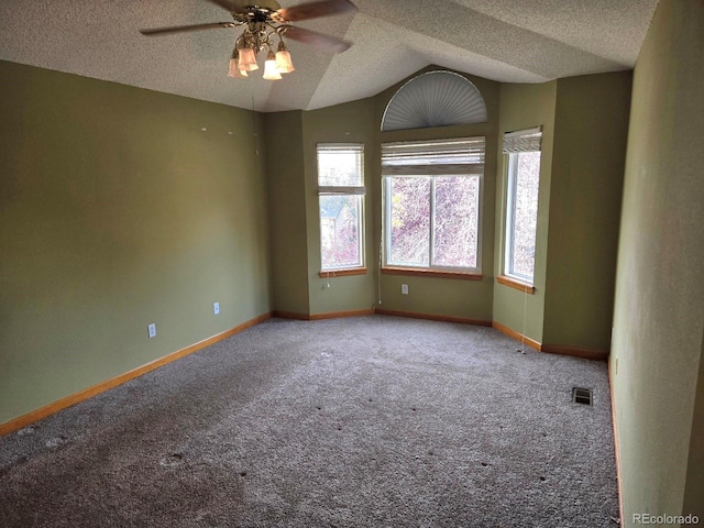 carpeted spare room with ceiling fan, a textured ceiling, and lofted ceiling