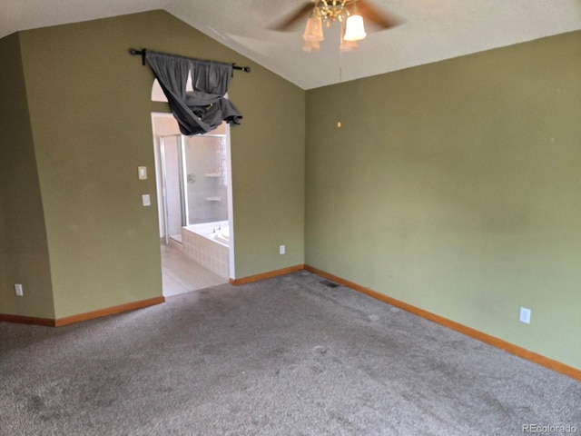 spare room with ceiling fan, light colored carpet, and lofted ceiling