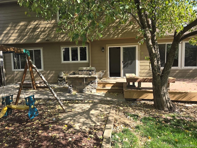 rear view of house with a deck and a patio area