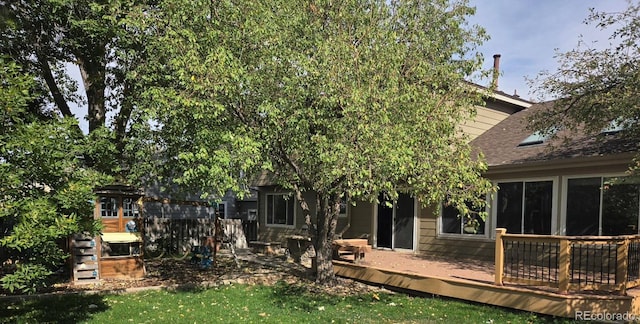 rear view of property with a wooden deck