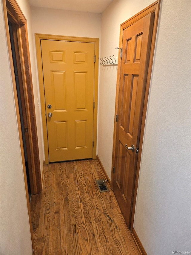 hall with dark hardwood / wood-style flooring