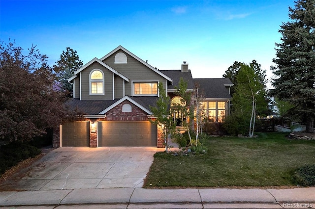 view of front of property with a front lawn, a chimney, a shingled roof, an attached garage, and driveway