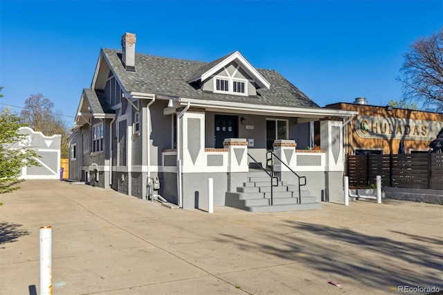 3929 Federal Blvd, Denver, CO 80211 - bungalow-style home with stucco siding, fence, a porch, a chimney, and a shingled roof