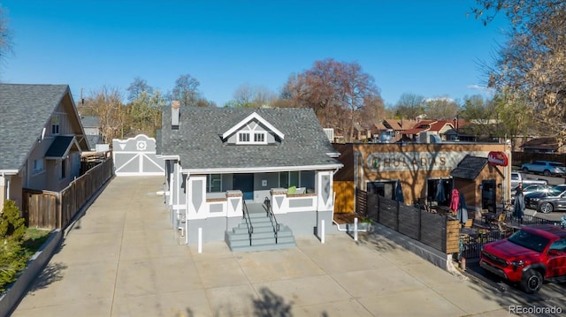 3929 Federal Blvd, Denver, CO 80211 - view of front facade featuring fence, a shingled roof, a chimney, and covered porch