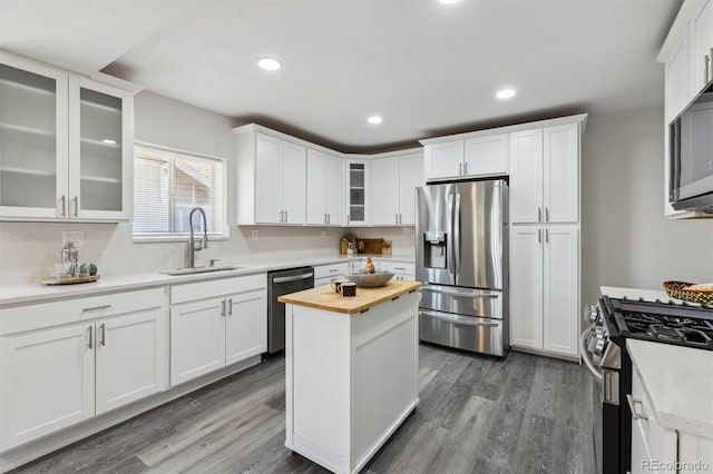 3929 Federal Blvd, Denver, CO 80211 - kitchen with appliances with stainless steel finishes, a sink, butcher block countertops, white cabinetry, and recessed lighting