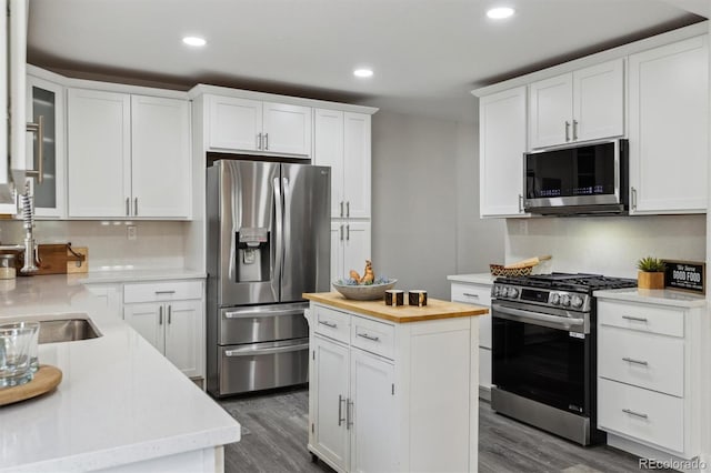 3929 Federal Blvd, Denver, CO 80211 - kitchen with stainless steel appliances, wooden counters, a sink, white cabinets, and recessed lighting