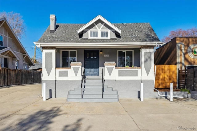 3929 Federal Blvd, Denver, CO 80211 - bungalow-style home featuring stucco siding, a chimney, fence, a porch, and roof with shingles