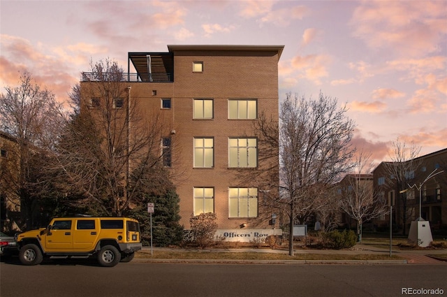 view of outdoor building at dusk