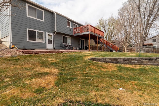 back of property featuring a deck, fence, a yard, stairs, and a patio area