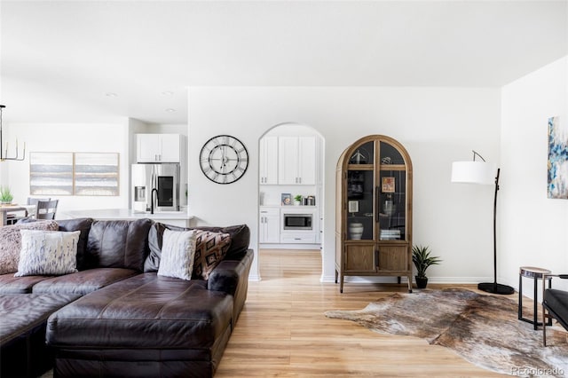 living room featuring sink and light hardwood / wood-style floors