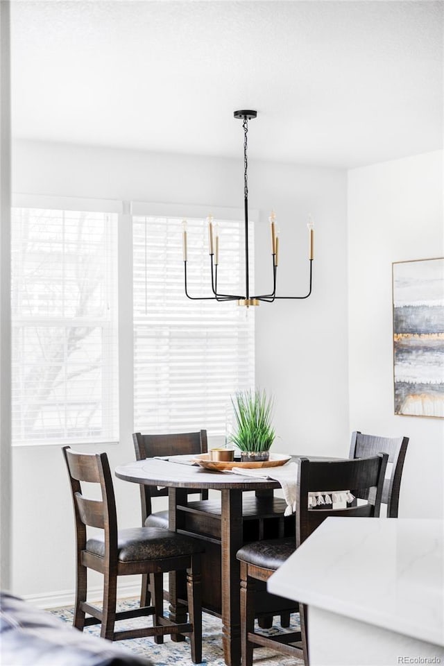 dining area featuring plenty of natural light and a chandelier