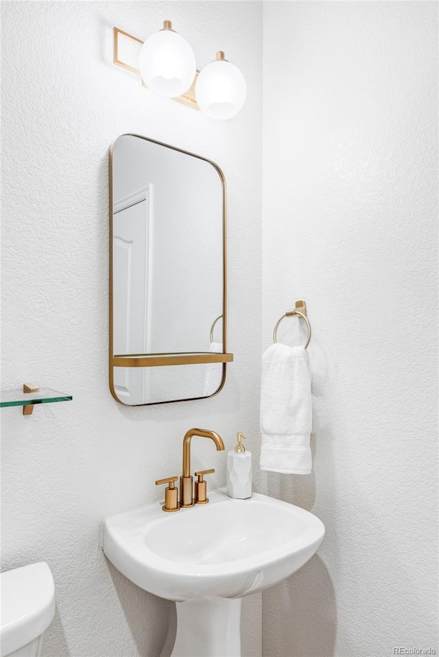 bathroom featuring sink and toilet