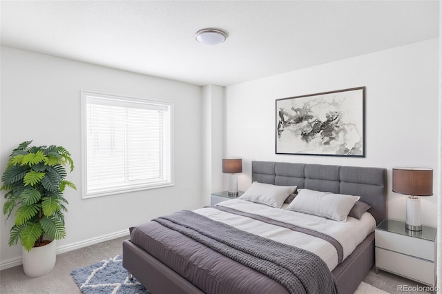 bedroom featuring light carpet