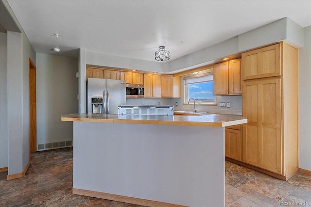 32800 E 137th Way, Brighton, CO 80603 - kitchen with appliances with stainless steel finishes, a sink, stone finish flooring, and baseboards