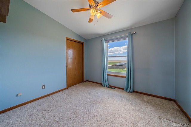 32800 E 137th Way, Brighton, CO 80603 - carpeted spare room featuring vaulted ceiling, baseboards, and ceiling fan