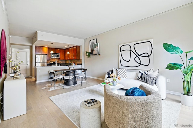 living room featuring light wood-type flooring and baseboards