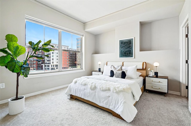 carpeted bedroom with baseboards and a view of city