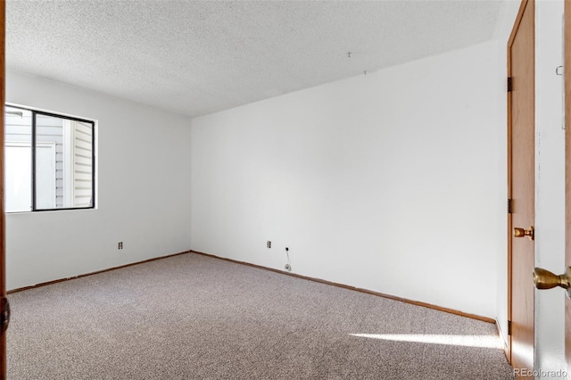 8701 Huron St Unit 5-210, Thornton, CO 80260 - carpeted spare room featuring a textured ceiling and baseboards