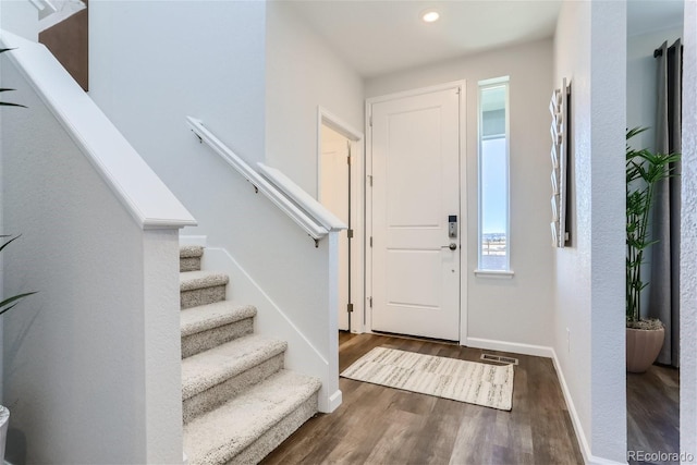 foyer with stairway, wood finished floors, visible vents, baseboards, and recessed lighting