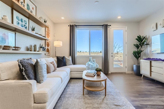 living area with recessed lighting and wood finished floors