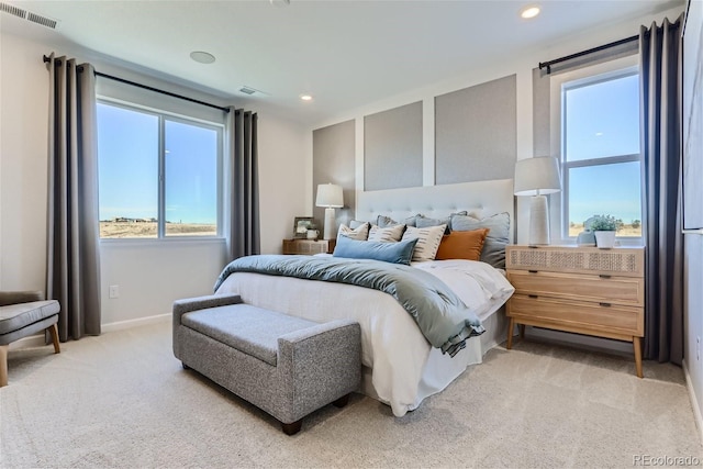 bedroom featuring recessed lighting, visible vents, light carpet, and baseboards