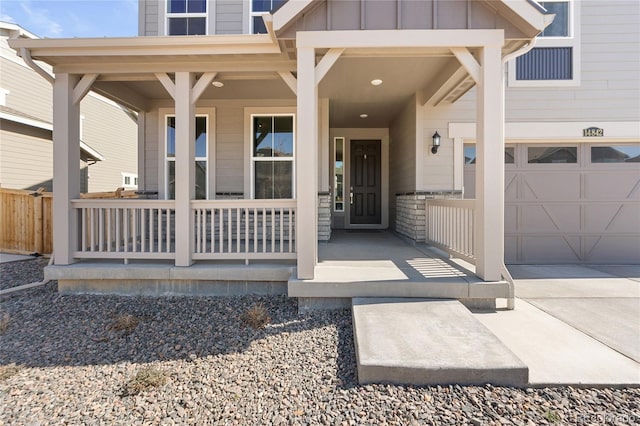 doorway to property with board and batten siding and covered porch