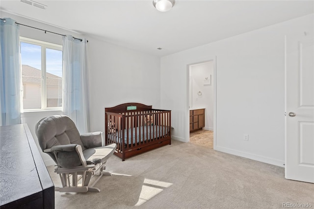 carpeted bedroom with visible vents and baseboards