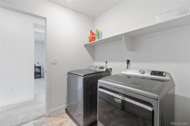 laundry room with visible vents, baseboards, light colored carpet, laundry area, and washer and dryer