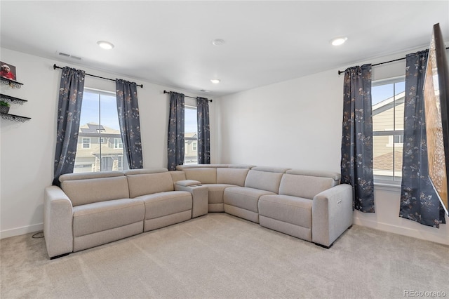 living room featuring recessed lighting, baseboards, plenty of natural light, and carpet