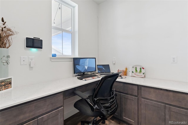 office space featuring dark wood-style flooring and built in study area