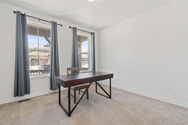 home office featuring visible vents, light carpet, and a healthy amount of sunlight