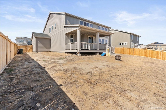 back of property featuring an outdoor fire pit and a fenced backyard