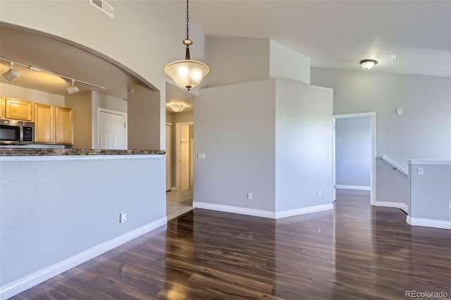 kitchen with pendant lighting, dark hardwood / wood-style flooring, vaulted ceiling, and light brown cabinets