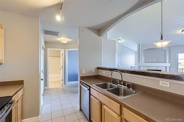 kitchen with lofted ceiling, sink, decorative light fixtures, light tile patterned floors, and stainless steel appliances