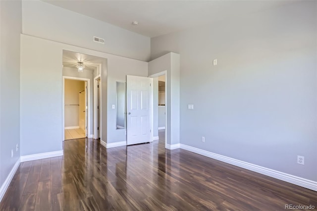 unfurnished room with dark hardwood / wood-style flooring