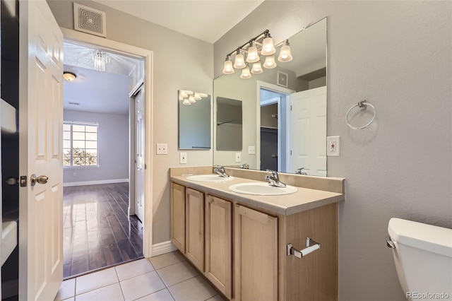 bathroom with tile patterned floors, toilet, and vanity