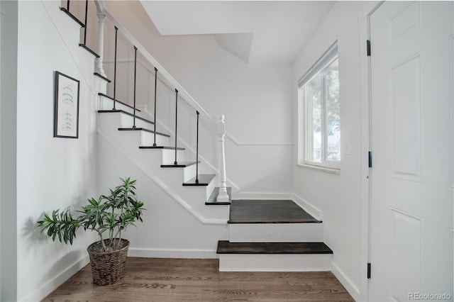 stairway with baseboards and wood finished floors