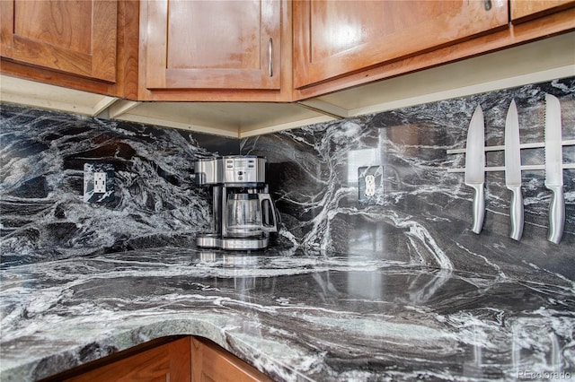 interior details featuring tasteful backsplash and brown cabinets