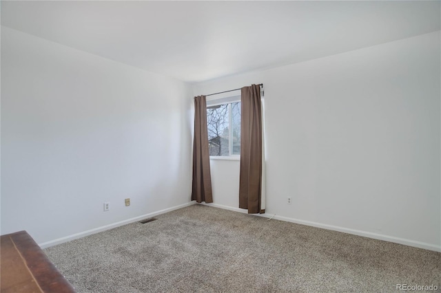 empty room with visible vents, carpet flooring, and baseboards