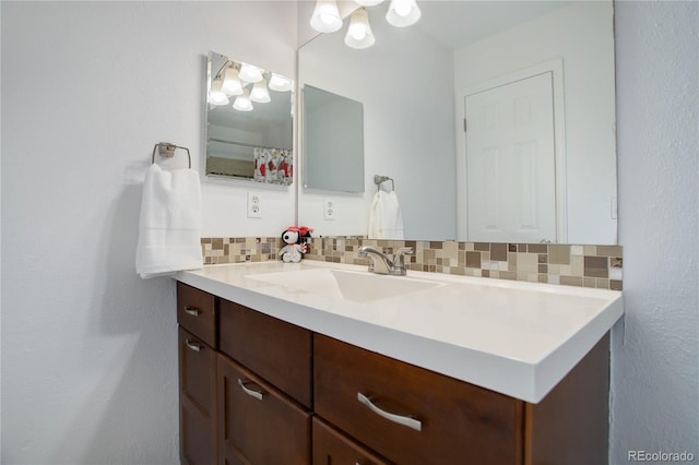 full bath with decorative backsplash and vanity