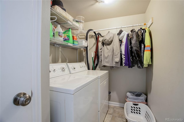 laundry room with laundry area, washing machine and dryer, and baseboards