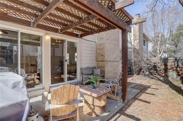 view of patio with a pergola and fence