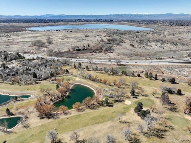 drone / aerial view featuring a water and mountain view