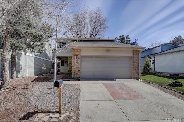 view of front of house with brick siding, an attached garage, and concrete driveway