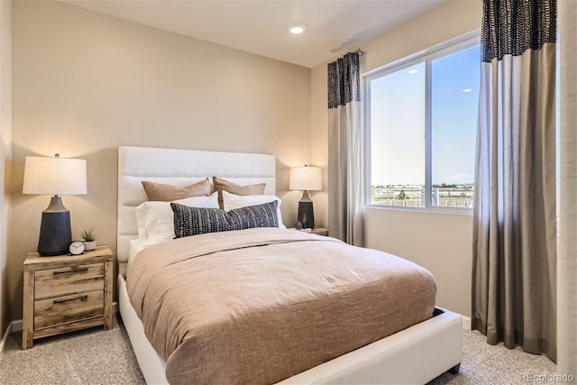 bedroom featuring light carpet