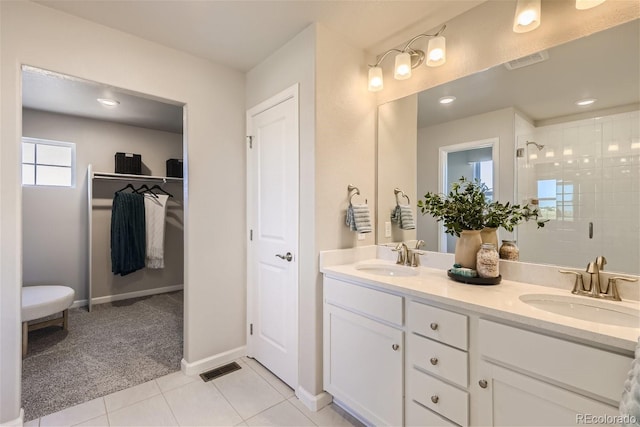 bathroom with tile patterned flooring, vanity, and a shower with shower door